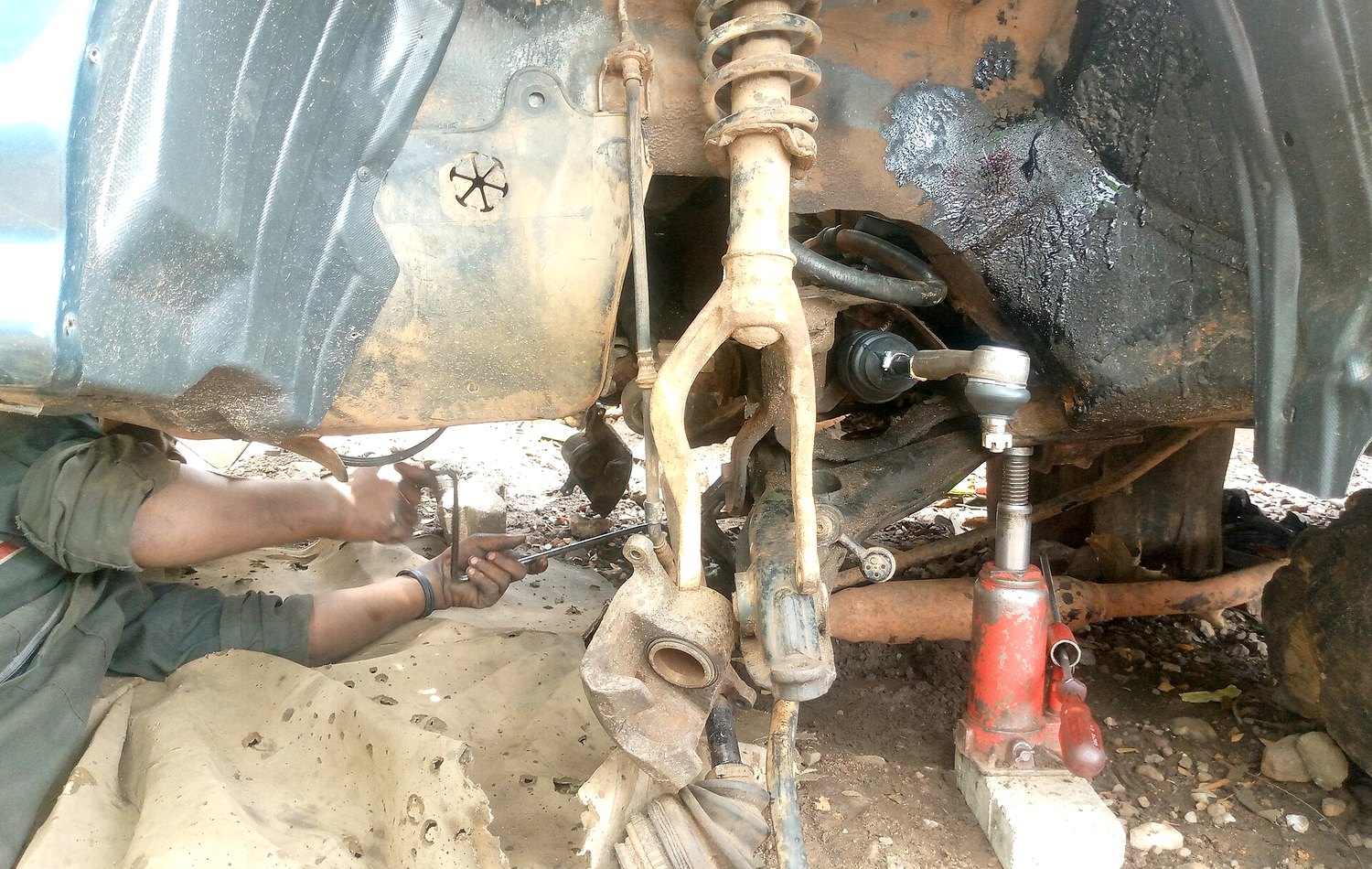 Garage service bay with a vehicle under inspection