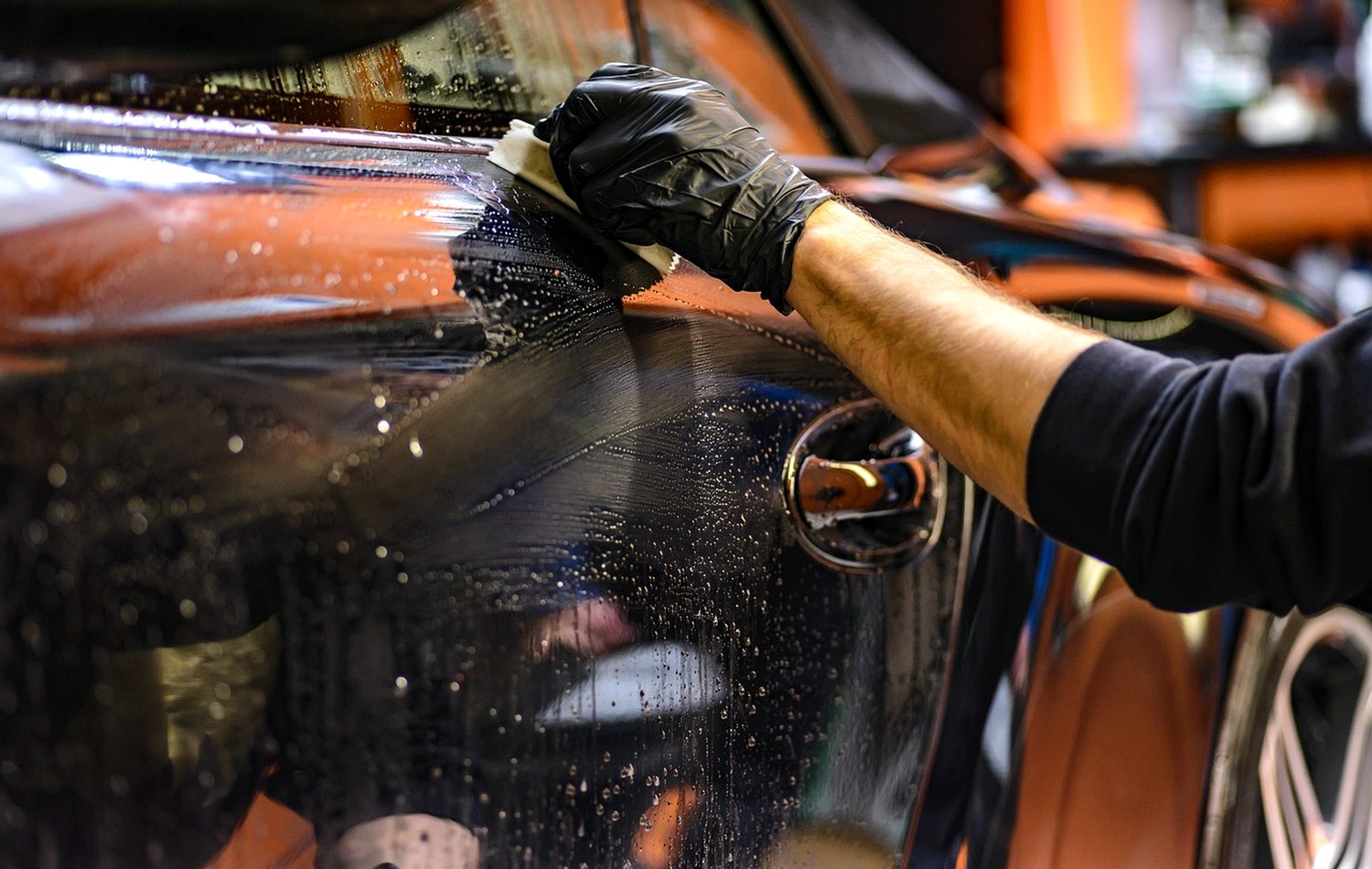 Detailing mitt working over wet car paint