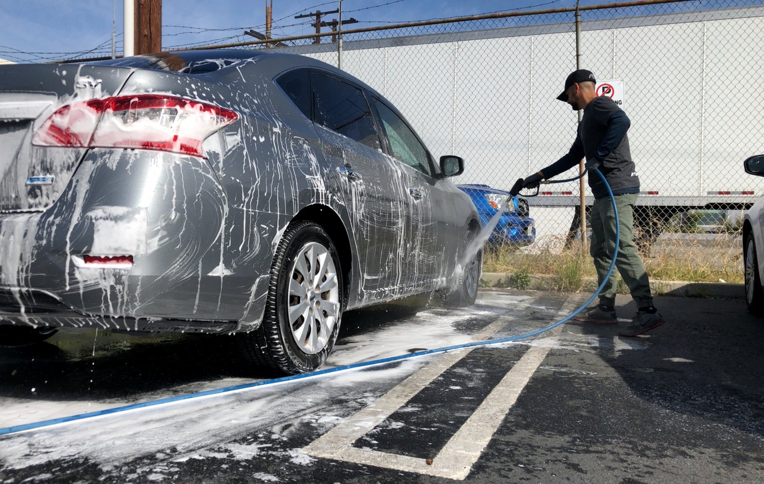 Car wash foam over exterior paint during a driveway wash