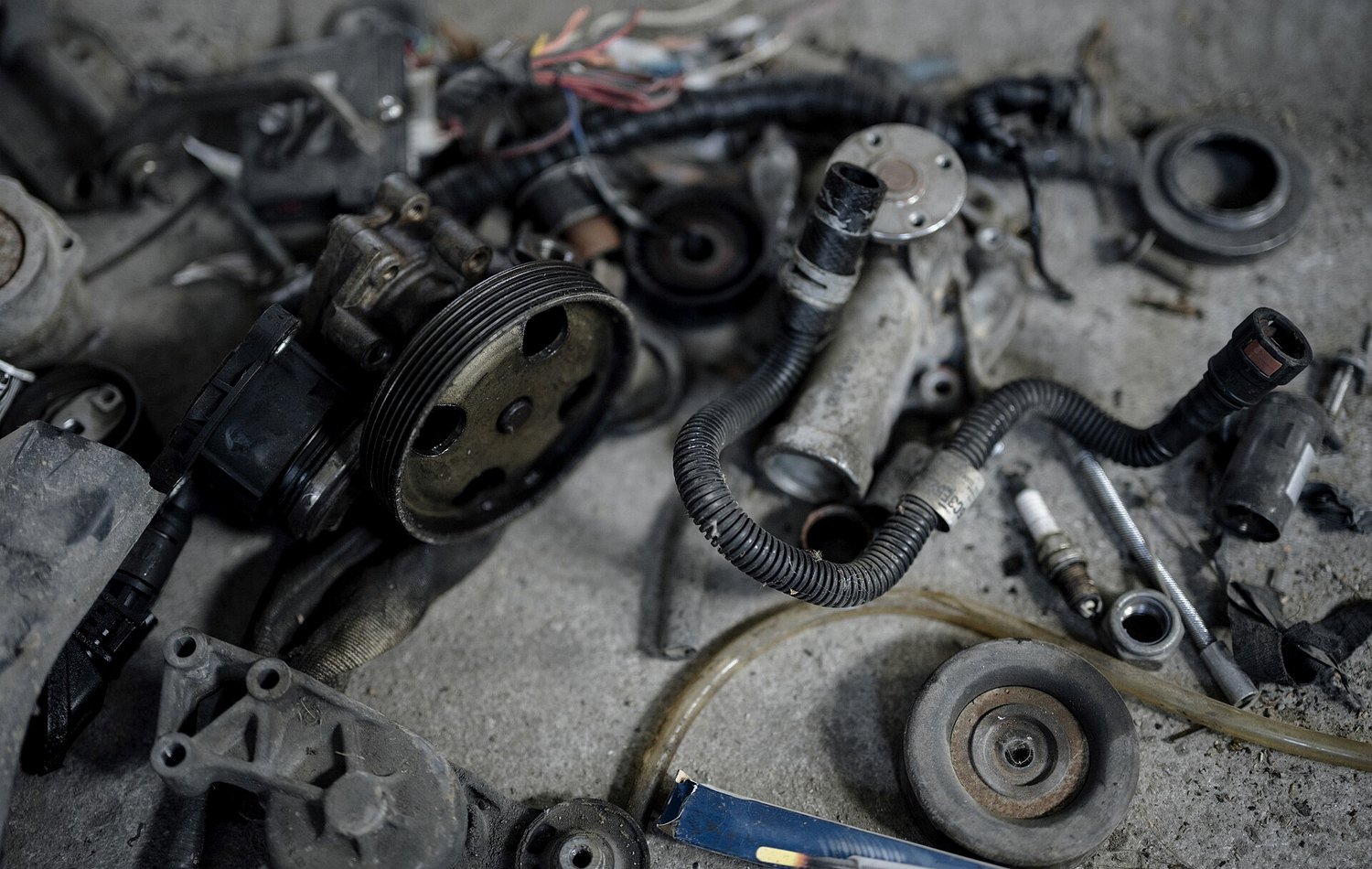Workshop floor with car parts and hand tools