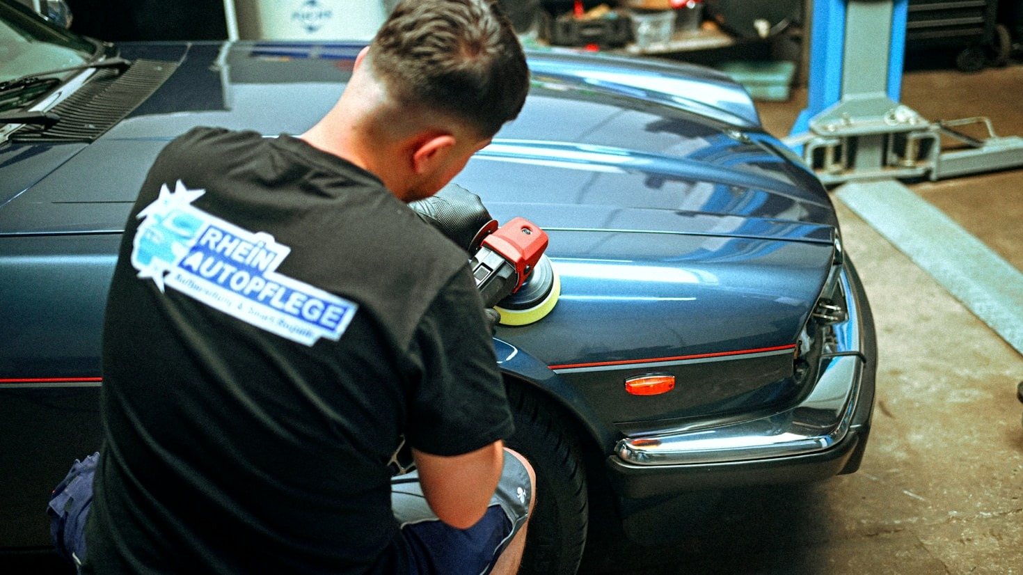 Paint correction bottles and microfiber towels on a garage bench